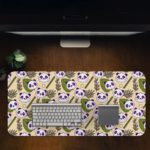 The cute panda desk mat has adorable panda faces and green leaves on a white and sandal background. Design Kept on a computer table