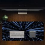 Infidu Minimalist Design Desk Pad features a blue and black background with abstract vector art, resembling speed lines or a starburst effect. Desk Pad in computer table