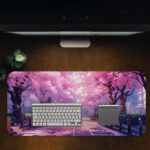 Desk mat featuring cherry blossom trees lining a peaceful pink and purple pathway. Desk Pad in computer table