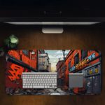 Desk pad showing a narrow street with colorful buildings and graffiti, creating a dynamic urban atmosphere. Desk Pad in computer table