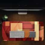 Infidu Artistic Desk Mat with an abstract composition of overlapping rectangular shapes in red, orange, and beige tones. Desk Pad in computer table