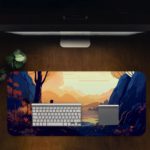 Desk pad featuring a person sitting by a tree, with a calm view of mountains and water in soft orange, blue, and purple tones. Desk Pad in computer table