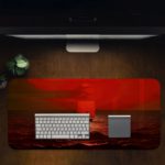 Infidu desk pad featuring a small boat on a red ocean under a red sky, capturing a serene sunrise or sunset scene. Desk Pad in computer table