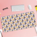 Desk pad with a white background featuring a pattern of small blue and purple flowers or geometric shapes. Desk Pad with Keyboard and Mouse