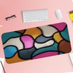 Infidu Artistic Desk Mat with organic, curving multicolored shapes in pink, light blue, yellow, gray, and white. Desk Pad with Keyboard and Mouse