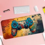 Gaming Desk Pad featuring a blue, red, and yellow controller with a sandal orange and yellow background, accented with vibrant paint splashes Desk Pad with Keyboard and Mouse pink background