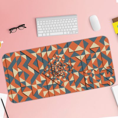 Desk pad with an abstract geometric pattern in blue, orange, and white, featuring triangles and various shapes. Desk Pad with Keyboard and Mouse