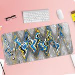 Infidu Artistic Desk Pad with a fluid, wavy pattern in blue, white, yellow, and gray, covering the entire surface. Desk Pad with Keyboard and Mouse