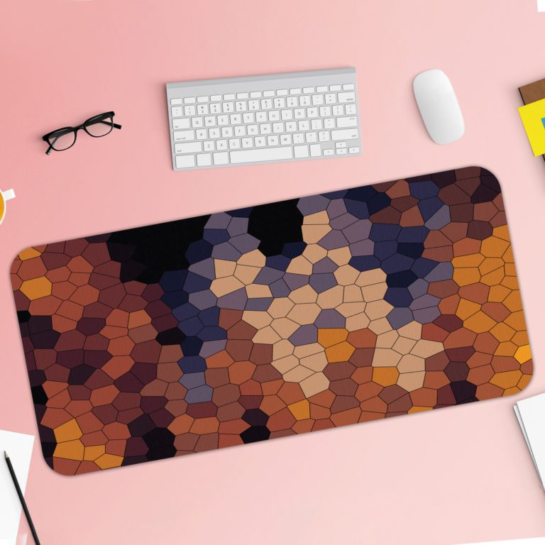 Desk mat featuring an abstract mosaic pattern with irregular shapes in shades of black, blue, gray, and yellow. Desk Pad with Keyboard and Mouse