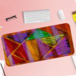 Infidu Artistic Animated Desk Pad with overlapping triangular and rectangular shapes in purple, red, green, orange, and yellow. Desk Pad with Keyboard and Mouse