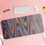 Infidu Artistic Patterns Desk Mat with smooth, flowing marble-like design in soft blue, white, and gray with light brown accents. Desk Pad with Keyboard and Mouse