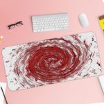 Infidu Artistic Desk Pad with a swirling vortex pattern in red, white, and black. Desk Pad with Keyboard and Mouse