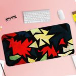 Infidu Artistic Patterns Desk Pad with sharp, jagged shapes in a zigzag design featuring bold colors like red, white, green, and black. Desk Pad with Keyboard and Mouse