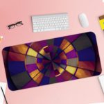 Infidu Artistic Patterns Desk Pad features a vibrant spiral design with rich colors including deep reds, oranges, yellows, purples, and blues. Desk Pad with Keyboard and Mouse