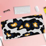 Infidu Artistic Patterns Desk Pad with a black background and large, irregular white and orange abstract shapes. Desk Pad with Keyboard and Mouse