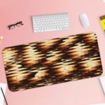 Infidu Artistic Patterns Desk Pad with a dark brown and black wave-like pattern highlighted with golden accents, creating a warm glow. Desk Pad with Keyboard and Mouse