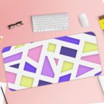 Infidu Artistic Desk Pad with geometric design in pastel pink, purple, blue, and yellow on a light background. Desk Pad with Keyboard and Mouse