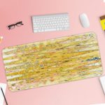 Infidu Artistic Patterns Desk Pad with a yellow and light brown background and vibrant abstract patterns in orange, green, and white. Desk Pad with Keyboard and Mouse