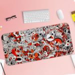 Red and gray desk pad with swirling, energetic shapes and doodle art. Desk Pad with Keyboard and Mouse