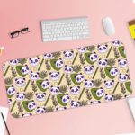 The cute panda desk mat has adorable panda faces and green leaves on a white and sandal background. Desk Pad with Keyboard and Mouse