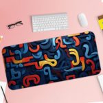 Infidu Desk Pad with a funky pattern of abstract curved shapes in blue, red, and yellow. Desk Pad with Keyboard and Mouse