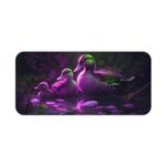 Artistic desk pad with a glowing duck family in purple and green on a dark background with water reflections. Desk Pad kept on a plain white background