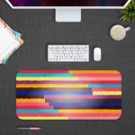 Infidu Artistic Desk Pad with horizontal stripes in pink, yellow, purple, blue, and red. Design Kept on a computer table