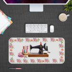 Infidu Modern Stitch Sewing Machine Desk Pad with White Background and Yellow, Pink, and White Flower Corners Desk Pad kept on a plain gray background