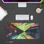 Infidu Artistic Desk Pad with angular abstract shapes in green, pink, purple, and yellow. Design Kept on a computer table