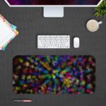 Infidu Artistic Desk Pad with elegant abstract shattered glass pattern in green, blue, purple, and yellow on a dark background. Desk Pad with Design Kept on a computer table