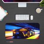 Desk pad featuring a stylized sports car in motion with blue, yellow, and orange light trails. Design Kept on a computer table