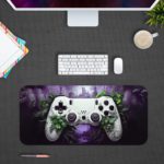 Gaming desk pad featuring a colorful game controller against a green, black, and violet background with dynamic paint splashes Desk Pad on the computer table