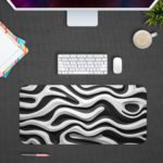 Infidu Artistic Pattern Desk Pad with a black background and parallel white wave lines. Design Kept on a computer table