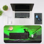 Desk pad featuring an anime character in a powerful pose with a sword, set against a vivid green background. Desk Mat with an Apple Laptop