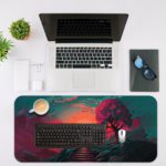 Desk pad featuring a fantastical landscape with a vibrant sky, silhouetted tree, and staircase leading into the distance. Desk Mat with an Apple Laptop