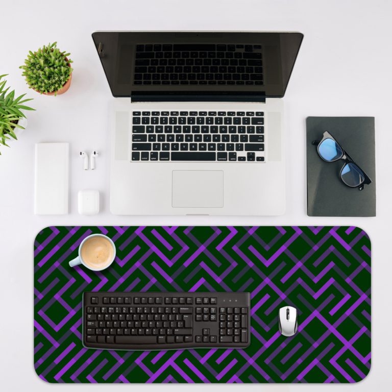 Dark desk pad with a geometric pattern of maze-like green and purple lines, adding a stylish touch to your workspace. Desk Mat with in laptop