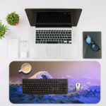 Large blue and white ocean waves against a purplish sky, create a dramatic seascape. Desk Mat with an Apple Laptop