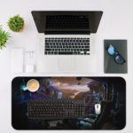 Futuristic desk pad with a control panel or cockpit design in cool blue and teal tones, set against a dark, space-like background. Desk Mat with an Apple Laptop