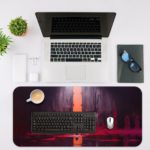 The silhouetted figure standing before a glowing orange portal, surrounded by deep purples and reds on the Infidu Artistic Desk Pad. Desk Mat with an Apple Laptop