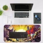 Infidu Color Splash Animated Desk Pad with a vibrant comic-style design, featuring purples, blues, yellows, and dynamic elements. Desk Mat with an Apple Computer