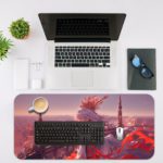 Anime queen with white hair and red accents in front of a fantasy cityscape with tall spires and a gray and white sky on a desk mat. Desk Mat with an Apple Laptop