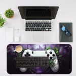 Gaming desk pad featuring a colorful game controller against a green, black, and violet background with dynamic paint splashes Desk Mat with an Apple Computer