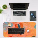 Infidu Whimsical Wonder Artistic Desk Pad Abstract Orange Desk Mat with an Apple Laptop