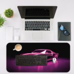 Infidu Artistic Desk Pad with a vintage sports car outlined in glowing purple neon against a dark background, creating a retro-futuristic look. Desk Mat with an Apple Laptop