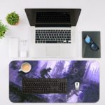 Desk pad with a silhouette of a motocross rider mid-jump against a foggy cityscape in blue and purple tones. Desk Mat with an Apple Laptop