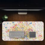 Infidu Artistic Desk Mat with speckled colorful dots in blue, red, yellow, and green on a white background. Desk Pad in computer table