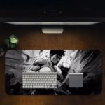 Desk pad with a grayscale illustration of a person in a fight, set against a gray and black background. Desk Pad in computer table