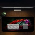 Colorful feather or leaf design with red, blue, green, and purple gradient pattern. Desk Pad in computer table