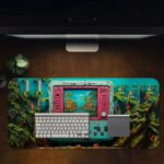 Artistic Gaming Desk Pad featuring an old-style handheld game console in light blue with pink buttons, displaying a scene of palm trees, blue sky, and huts that blend into the background Desk Pad in computer table