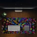 Infidu Artistic Desk Pad with elegant abstract shattered glass pattern in green, blue, purple, and yellow on a dark background. Desk Pad in computer table